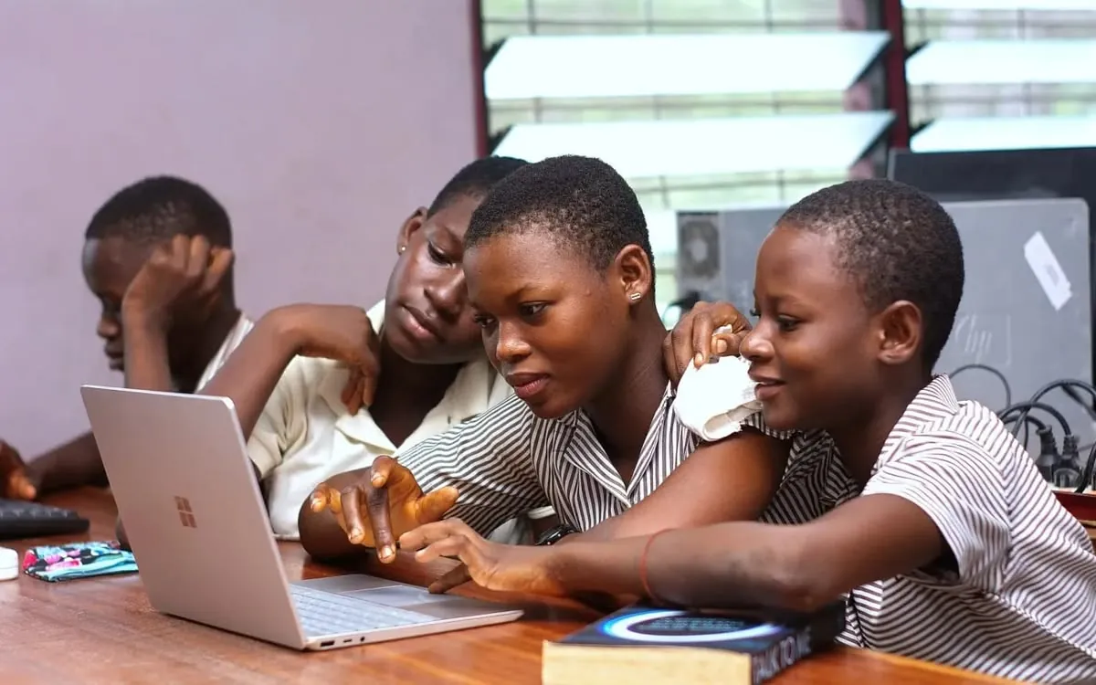 Young people working together on a laptop